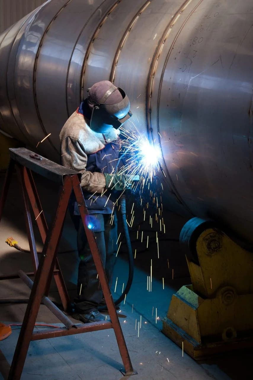 Professional welder on pressure vessel